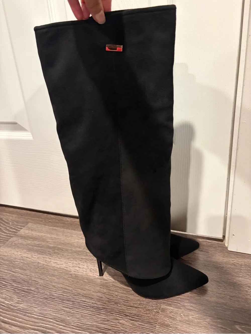 Black suede boots with pointed toe and stiletto heel